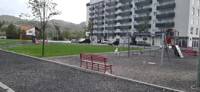 a playground with a red bench in a park at Comfort in Kiseljak