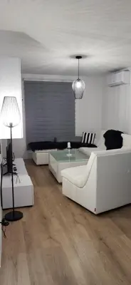 a living room with two white couches and a table at Comfort in Kiseljak