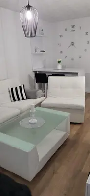 a living room with two white couches and a table at Comfort in Kiseljak