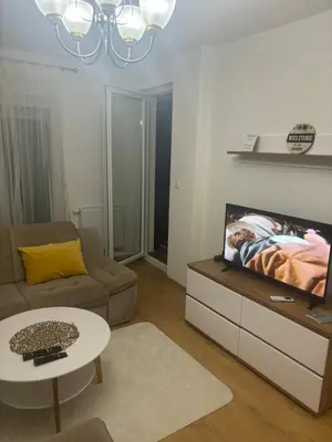 a living room with a couch and a tv at Apartman Aura in Travnik