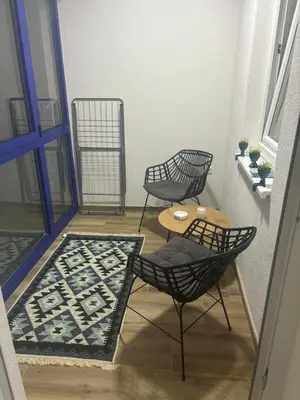 two chairs and a table on a balcony at Apartman Aura in Travnik