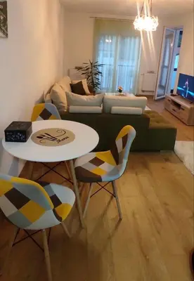 a living room with a couch and a table and chairs at Apartman Aurora in Travnik
