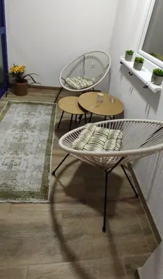 a living room with two chairs and a table at Apartman Aurora in Travnik