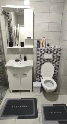 a bathroom with a toilet and a sink and a mirror at Apartman Aurora in Travnik