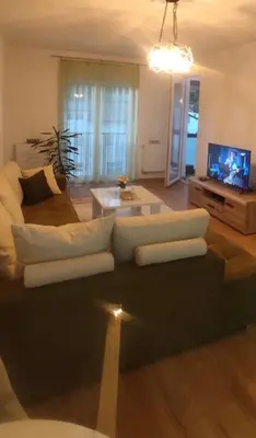 a living room with a couch and a tv at Apartman Aurora in Travnik