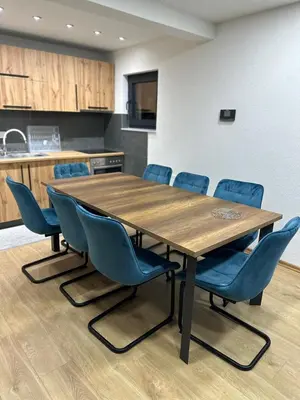 a conference room with a wooden table and blue chairs at Vila Flora Vlašić in Šišava