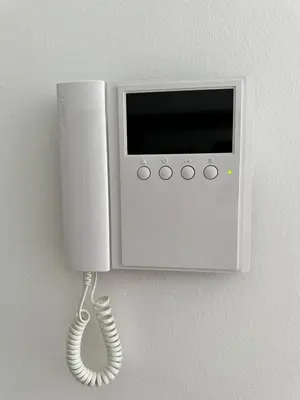 a telephone hanging on a wall with a handset at Studio Apartman Centar 2 in Livno