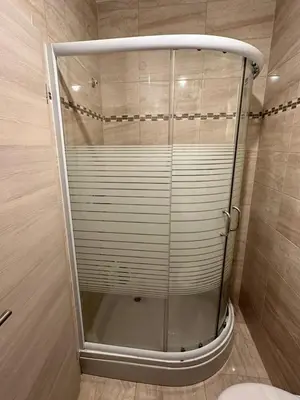 a shower with a glass door in a bathroom at Studio Apartman Centar 2 in Livno