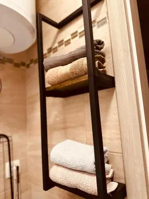 a bathroom with a towel rack with towels at Studio Apartman Centar 2 in Livno