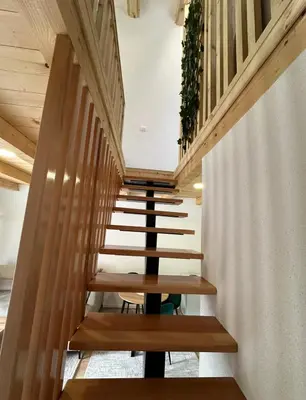 a staircase with wooden steps in a building at Ammirevole Ravne Oga in Visoko