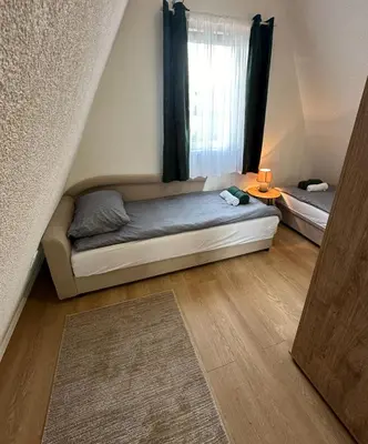a small bedroom with a bed and a window at Ammirevole Ravne Oga in Visoko