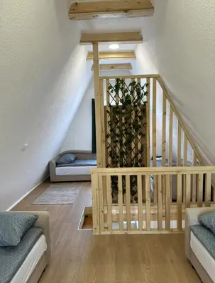 a room with a staircase with a bunch of wine bottles at Ammirevole Ravne Oga in Visoko