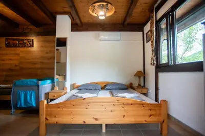a bedroom with a wooden bed in a room at Kuća za odmor Dani in Bihać