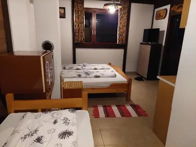 a small room with two beds and a window at Kuća za odmor Dani in Bihać