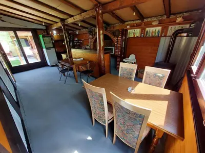 a dining room with a table and chairs in a train car at Kuća za odmor Dani in Bihać