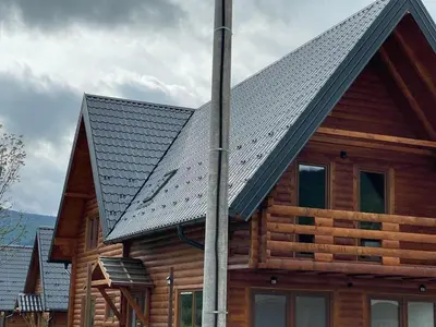 a house with a metal roof on top of it at Bungalow House - 5 Rooms in Zolaći