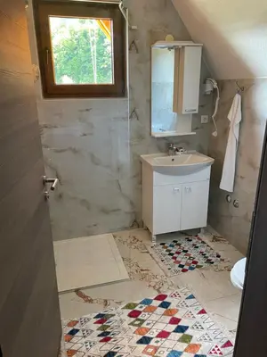 a bathroom with a sink and a mirror at Bungalow House - 5 Rooms in Zolaći