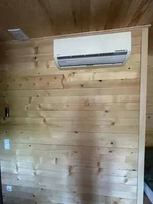 a room with a wood paneled wall with a heater at Bungalow House - 5 Rooms in Zolaći