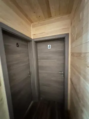 two metal doors in a hallway with the numbers at Bungalow House - 5 Rooms in Zolaći