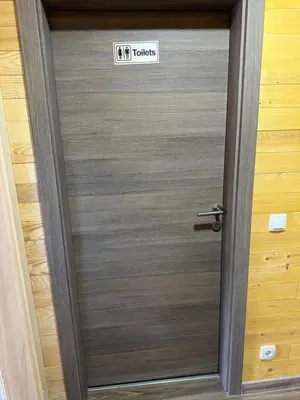 a metal door with a sign that reads it touches at Bungalow House - 5 Rooms in Zolaći