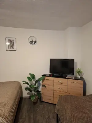 a bedroom with a flat screen tv on a dresser at Fly & Stay Apartments in Laktaši