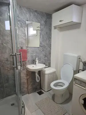 a bathroom with a toilet and a sink at Fly & Stay Apartments in Laktaši