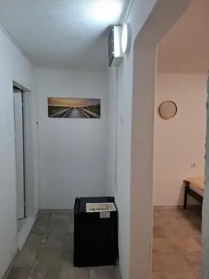 a room with a suitcase in the corner of a room at Fly & Stay Apartments in Laktaši