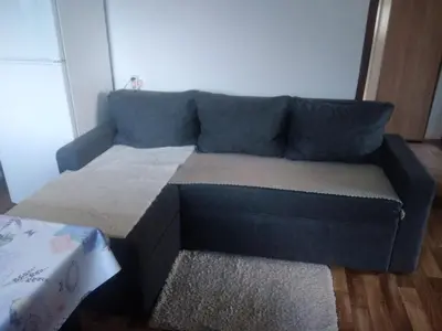 a blue couch sitting in a living room at Etno domaćinstvo in Bosanska Dubica