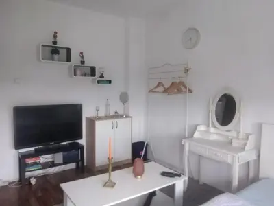 a living room with a tv and a table at Etno domaćinstvo in Bosanska Dubica