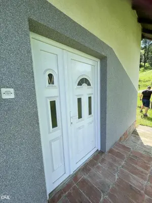 a white door on the side of a house at Etno domaćinstvo in Bosanska Dubica