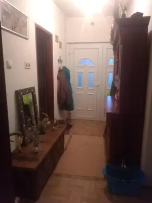 a hallway with a door and a table and a mirror at Etno domaćinstvo in Bosanska Dubica