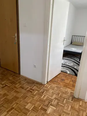 a hallway with a room with a bed and a wooden floor at Vista Castle in Jajce