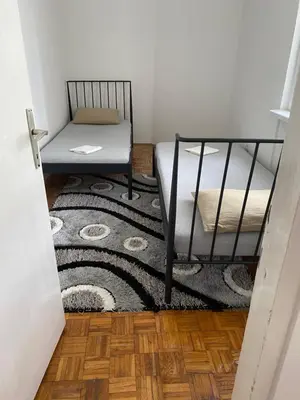 a bedroom with a bed and a chair and a rug at Vista Castle in Jajce