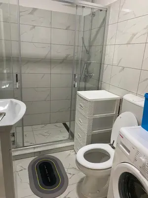 a bathroom with a shower and a toilet and a washing machine at Vista Castle in Jajce