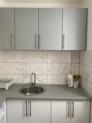 a kitchen counter with a sink and white cabinets at Vista Castle in Jajce