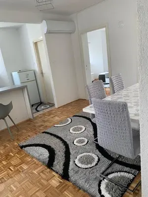 a living room with a table and chairs and a rug at Vista Castle in Jajce