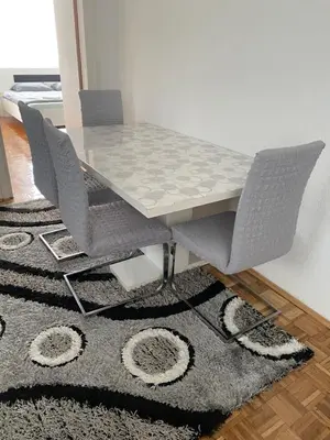 a dining room table with chairs and a rug at Vista Castle in Jajce