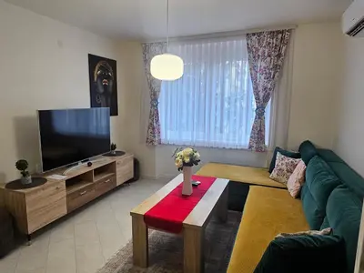 a living room with a couch and a television at Esma in Bihać