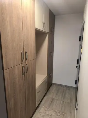 a closet with wooden cabinets and a wooden floor at Esma in Bihać