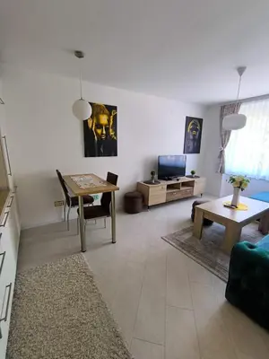 a living room with a table and a couch at Esma in Bihać