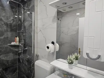 a bathroom with a toilet and a glass shower at Esma in Bihać