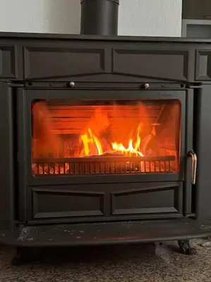 a stove with a fire inside of it at Apartman Latice in Tomislavgrad