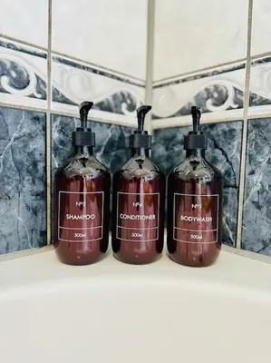 three bottles of alcohol sitting on a shelf at Apartman Latice in Tomislavgrad