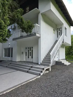 a white house with stairs in front of it at Riverstone Retreat in Jajce
