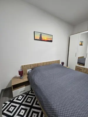 a bedroom with a bed and a picture on the wall at Riverstone Retreat in Jajce