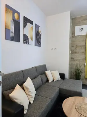 a living room with a couch and a table at Riverstone Retreat in Jajce