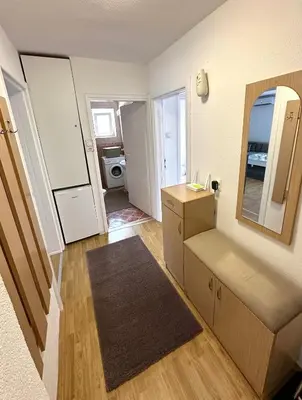 a small kitchen with a sink and a mirror at Apartman Lara Laktasi in Laktaši