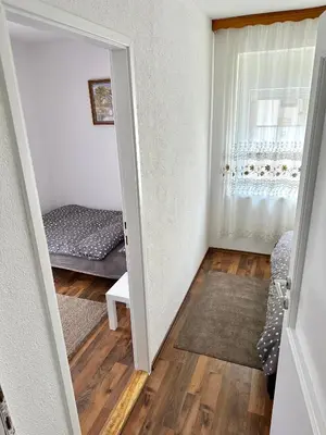 a room with a door leading to a bedroom at Apartman Lara Laktasi in Laktaši