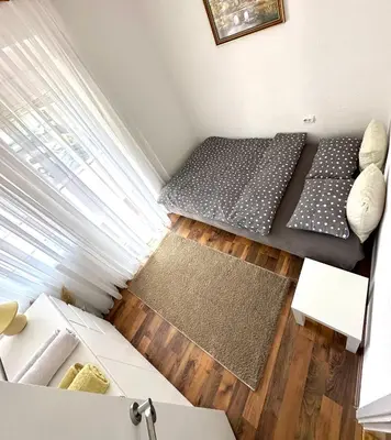 a small room with a couch and a table at Apartman Lara Laktasi in Laktaši