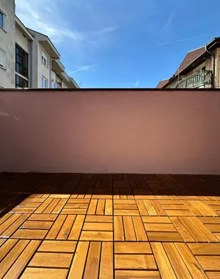 an empty balcony with a wooden floor and a wall at Apartman Lara Laktasi in Laktaši